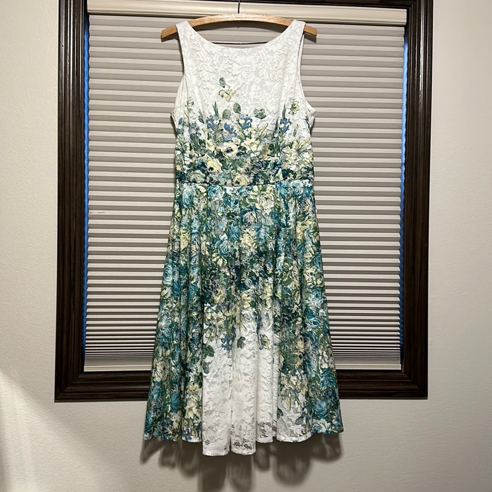 Women’s dress with lace floral overlay.